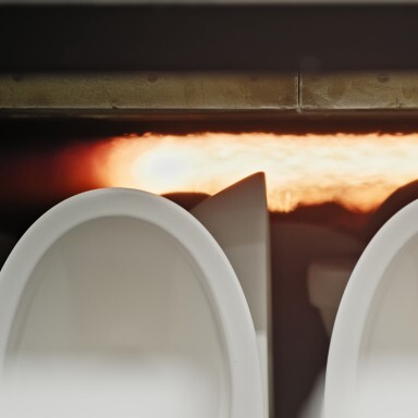 Close-up of urinals standing in front of the stove.