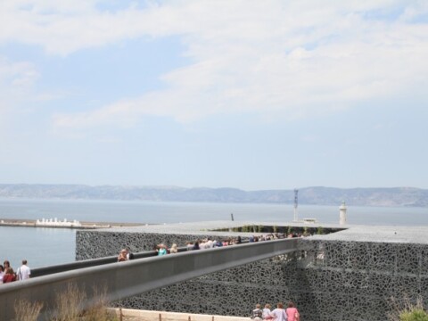 A long bridge leading to the building.
