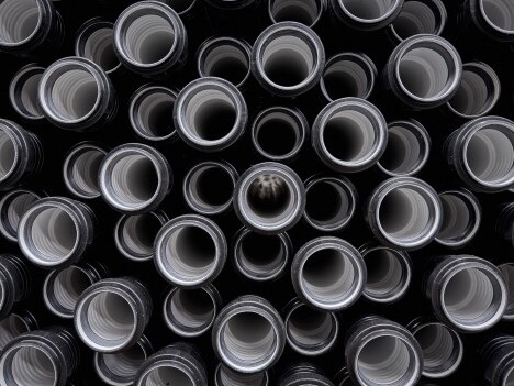 A close-up view of numerous circular pipes creating a layered effect with varying depths.