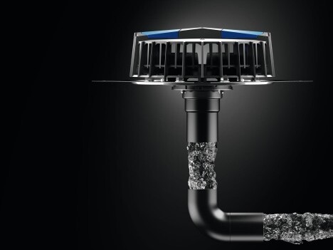 A black pipe with blue accents attached to a drain, set against a dark background.