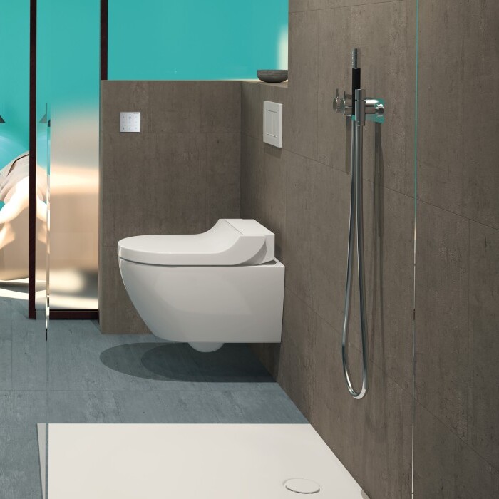 Modern bathroom with a floating sink, toilet, shower area, and turquoise accent wall.
