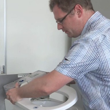 A person working on a toilet installation.