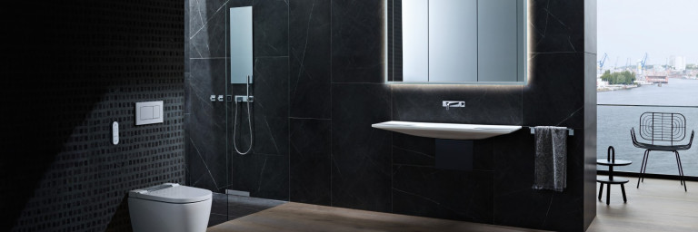 Modern bathroom with dark tiled walls, a sleek toilet, a wall-mounted sink and a large mirror.