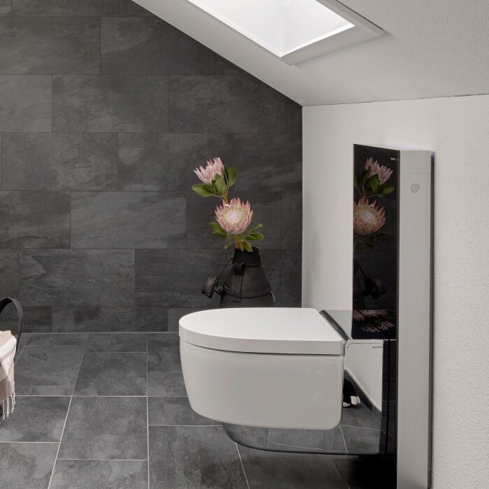 Spacious modern bathroom with gray tiled floor, white cabinetry, two sinks, and a minimalist toilet.