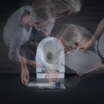 A blurred image showing an older person bending over a toilet, with multiple overlapping views of their head and hands engaged in some action.