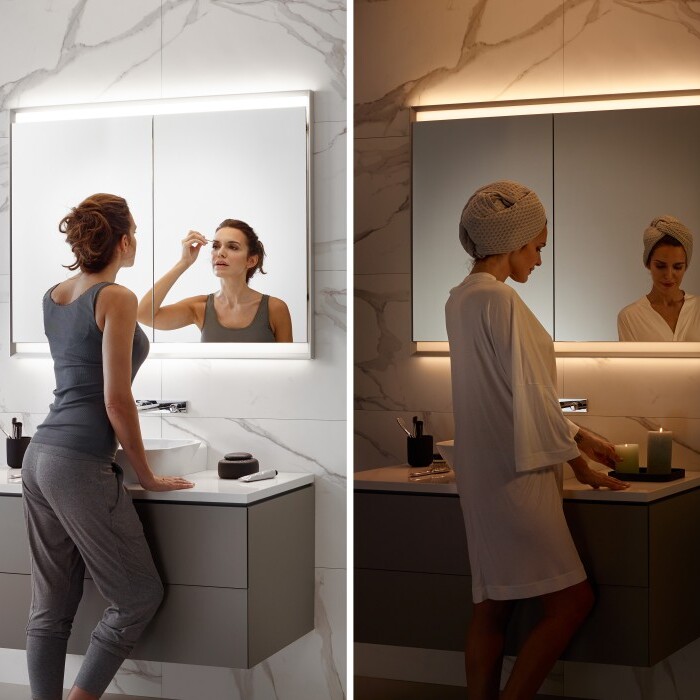 Eine moderne Badezimmer-Szene mit vier verschiedenen Personen, die sich vor einem beleuchteten Spiegel auf verschiedene Weisen fertig machen.