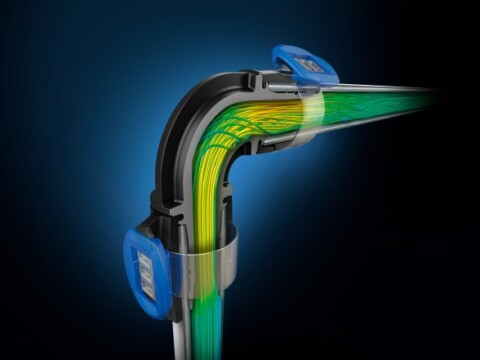 Eine grafische Darstellung eines Rohrbogens mit visualisierten Strömungslinien in verschiedenen Farben, die den Fluss von Flüssigkeit zeigen.