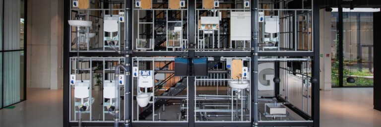 A modular display of interconnected mechanical components and frames, showcasing various sanitary equipment arranged in a grid-like structure.