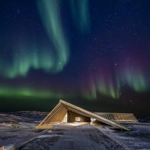 The Icefjord Centre in the spectacular northern lights of the Greenlandic polar night.