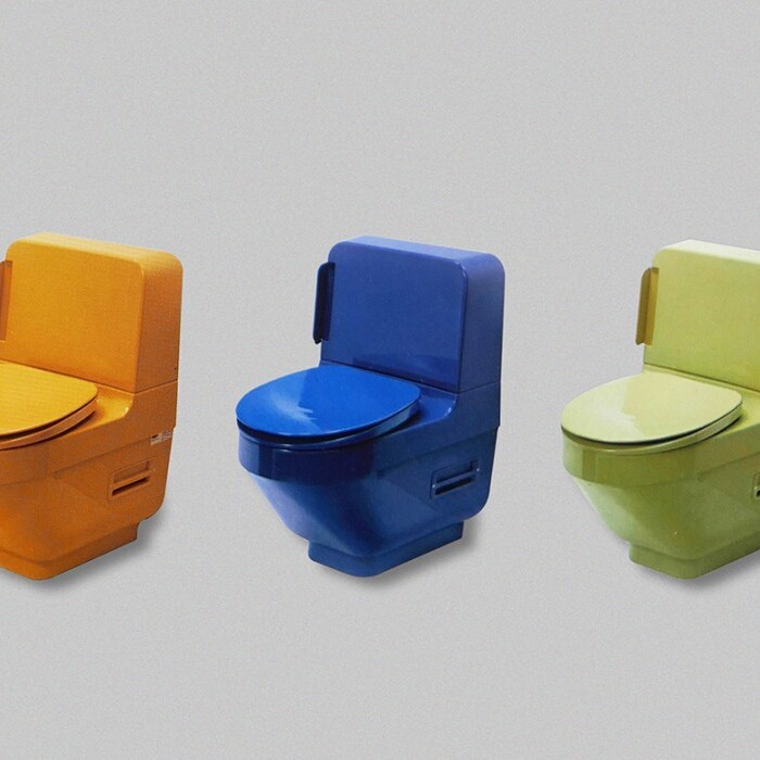 Five colorful toilets arranged in a row, including red, orange, blue, green, and beige.