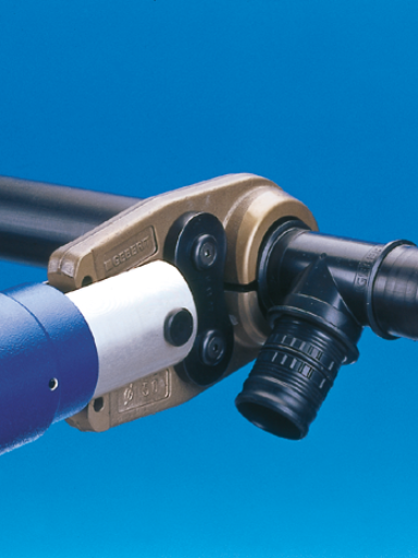 A close-up of a pipe tool with a metallic clamp and a blue handle, set against a blue background.