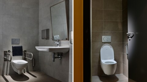 A comparison of two bathroom stalls: one with a grab bar and sink, and another with a standard toilet.