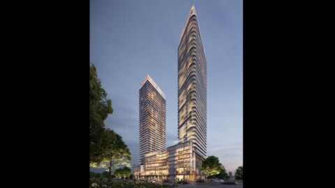 Zwei moderne Wolkenkratzer, von Bäumen umgeben und in der Dämmerung beleuchtet.