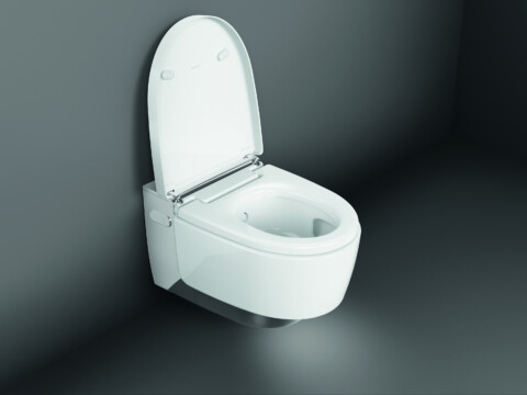 A modern white toilet with a raised lid set against a dark background.