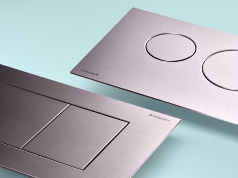 Zwei moderne Betätigungsplatten für WC-Spülungen, eine mit zwei runden Tasten und eine mit zwei eckigen Tasten.