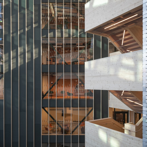 Modern building with big windows, and contrasting textured walls.