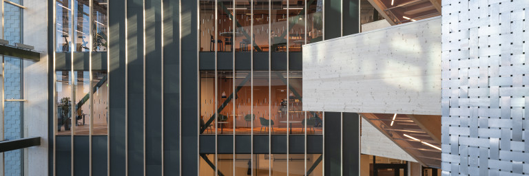 Modern building with big windows, and contrasting textured walls.