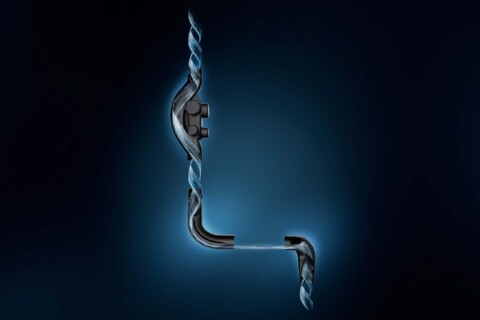 Ein technischer Schnitt durch eine L-förmige Rohrleitung, die aufzeigt, dass sich das Wasser darin spiralförmig bewegt.